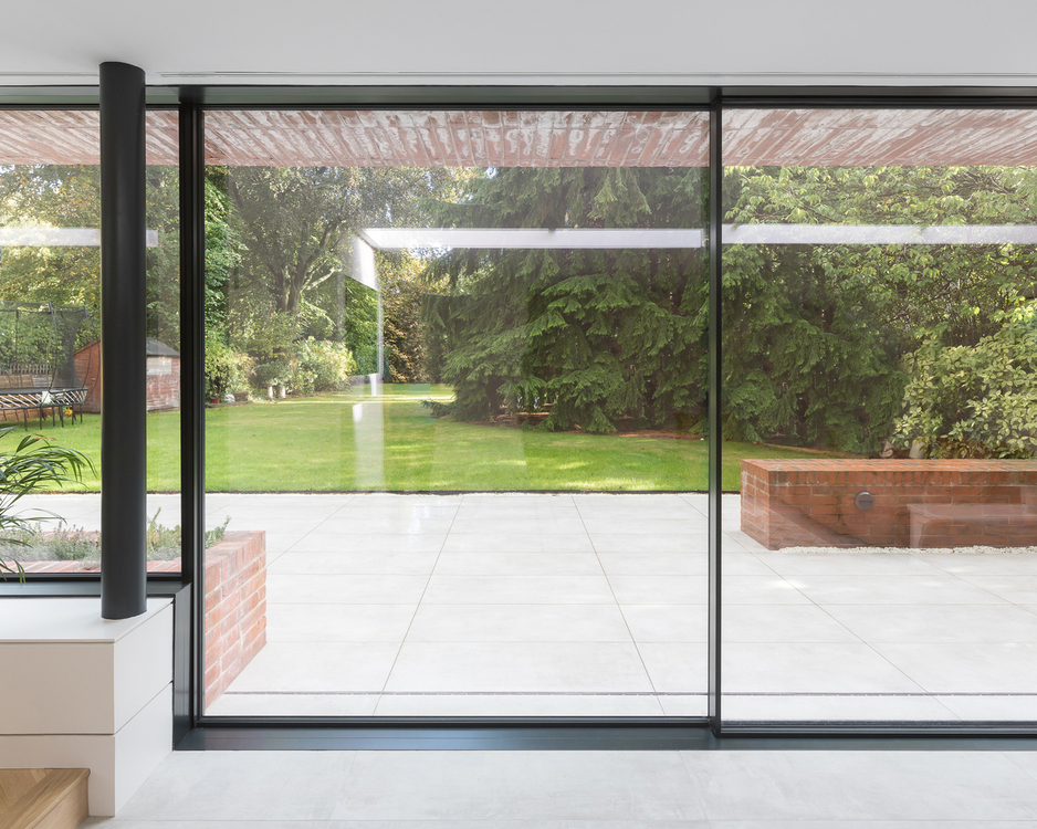 Ultraline slim framed sliding doors installed modern glass box extension